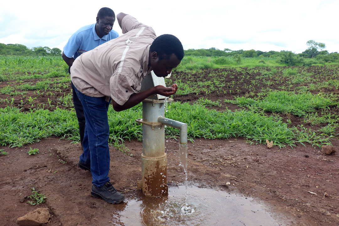 Area Impact Coordinator Chilobe Jongolo tasting the water.