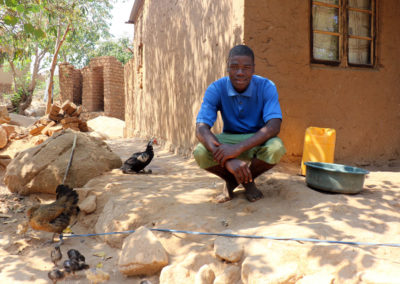 Alfred, member of Naotcha African Evangelical Church in Malawi, with his hen and chicks