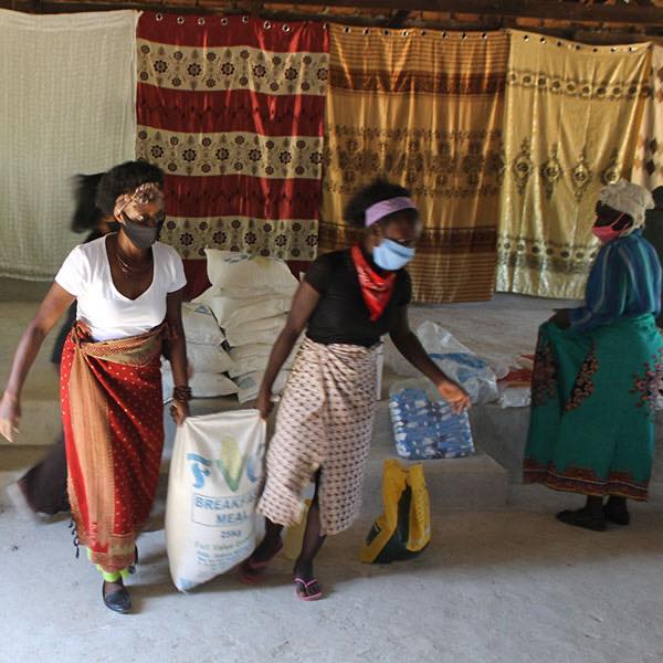 beneficiary carrying food hamper