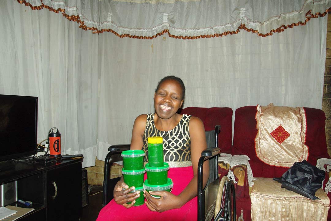 Lidia, seated in wheel chair with hand made dish