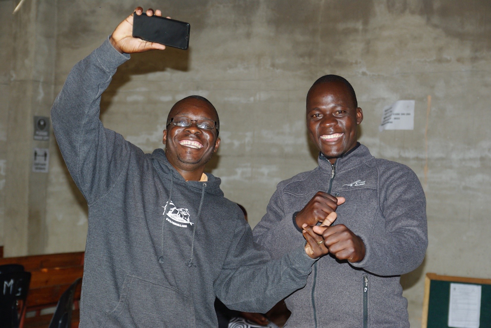 Two pastors at a church dancing.